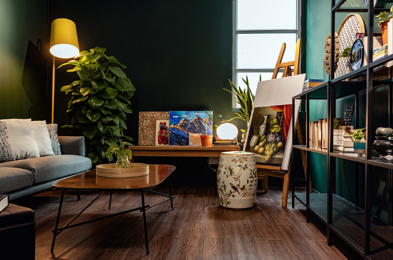 Image of a modern room lit by small lamps and filled with art materials and works