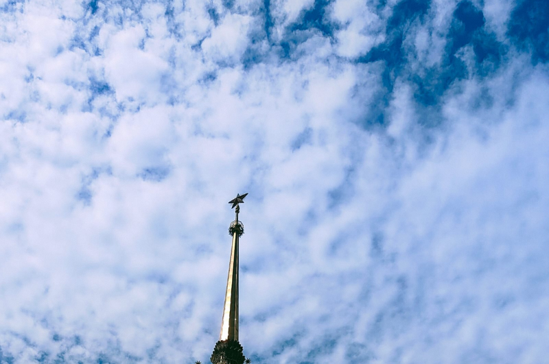 Pointed roof with sky background.