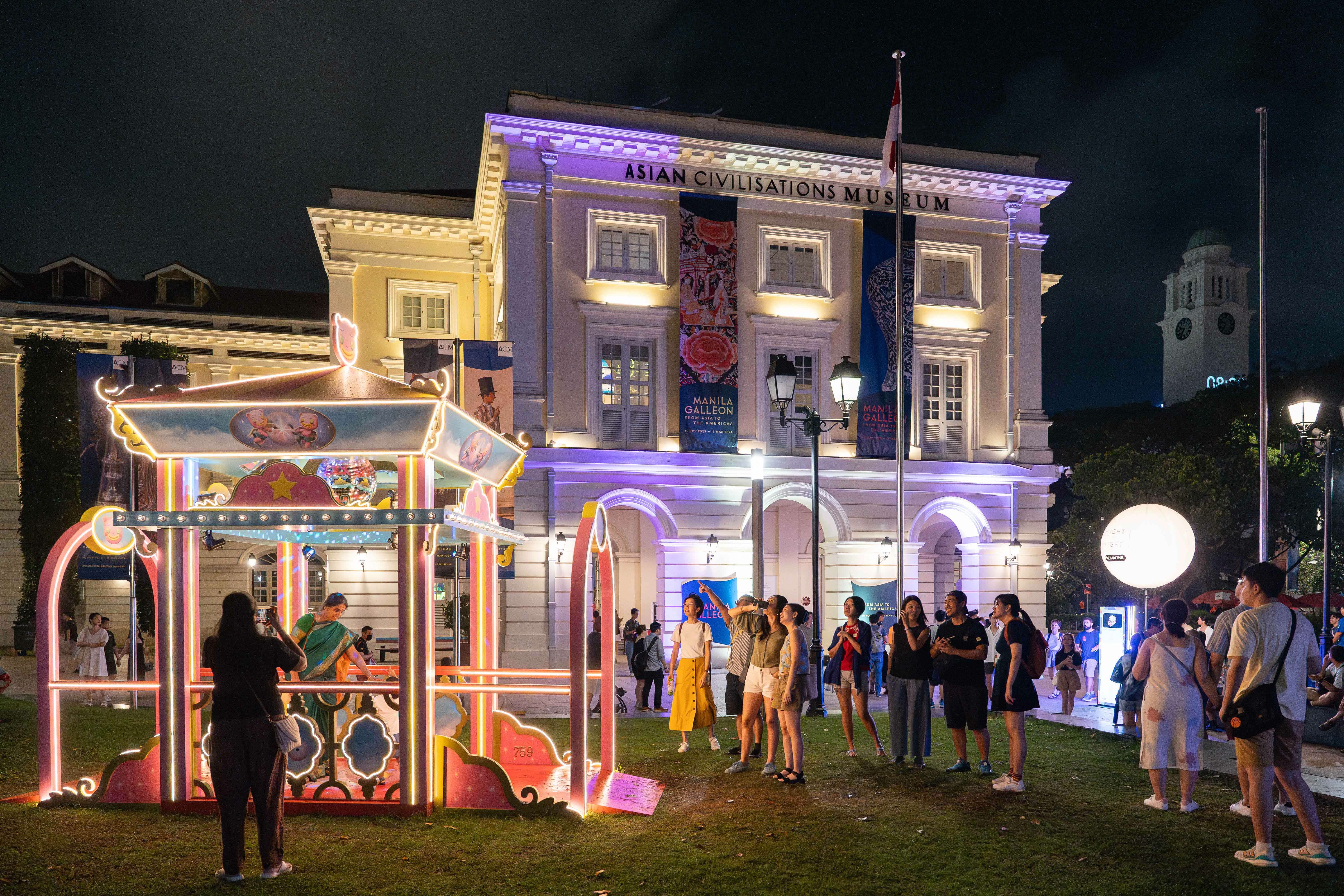 Image of the Asian Civilisations Museum facade lit up at night