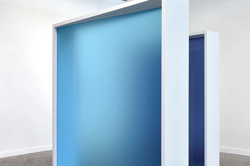 Image of white frames with blue frosted glass in a white gallery space