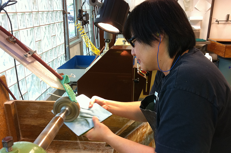 Image of woman printing on her glass art