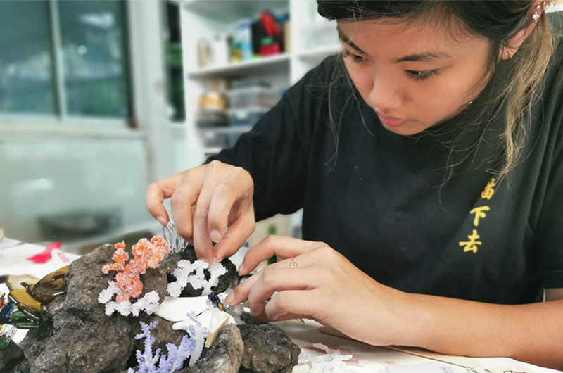 Image of woman making floral art pieces