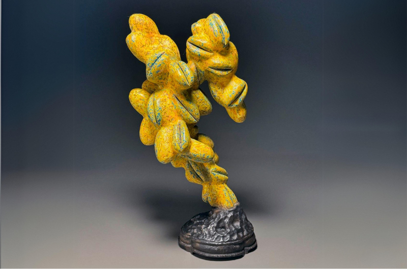 Image of yellow sculpture made of small shells