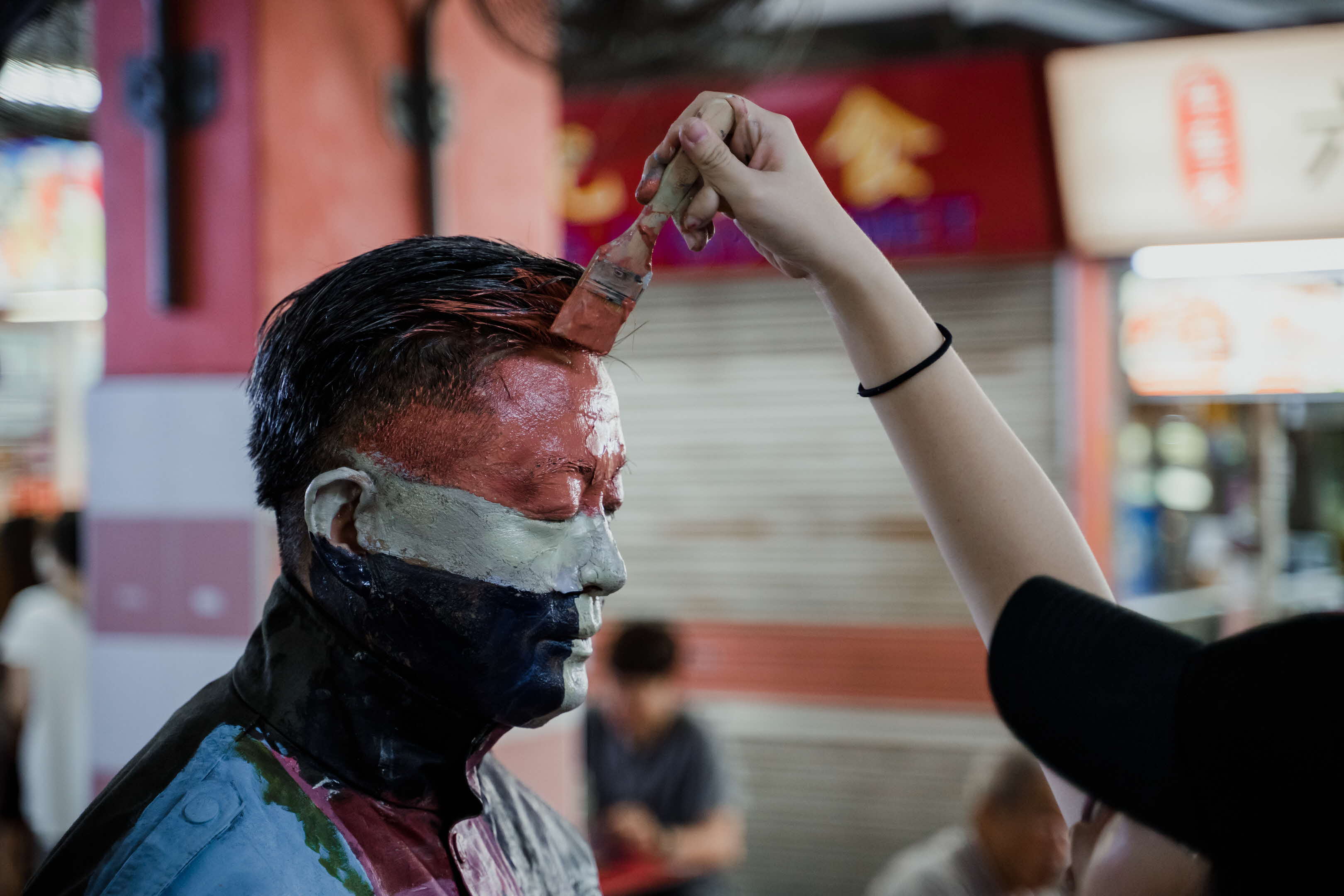 Process of painting person to blend in with food centre