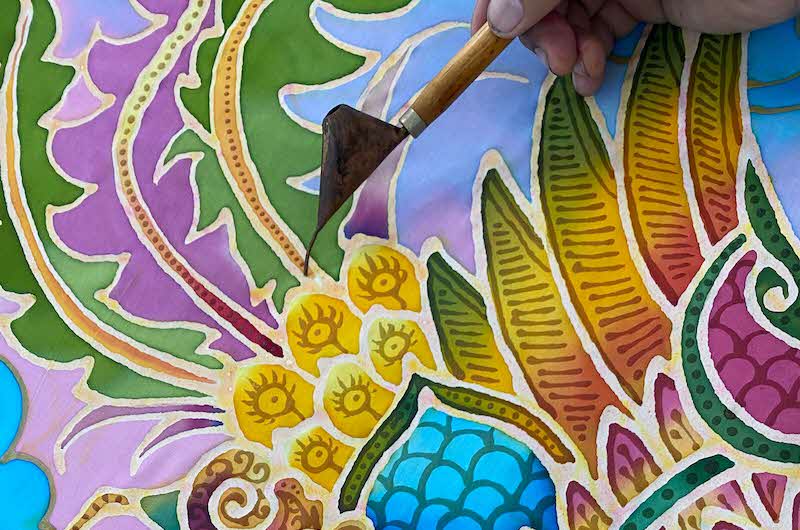 Painting in a batik print style with colourful gradients and floral motifs