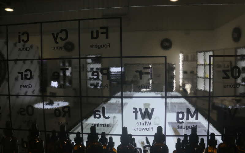 Transparent window with periodic table facing into an empty studio