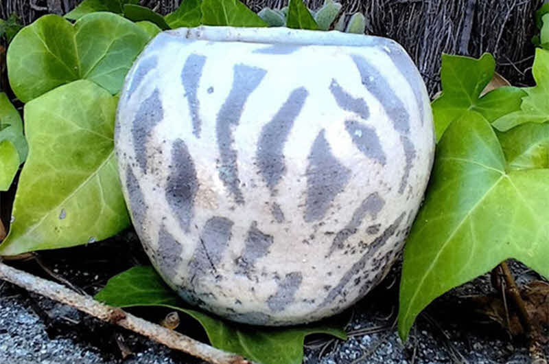 Image of ceramic artwork in foliage