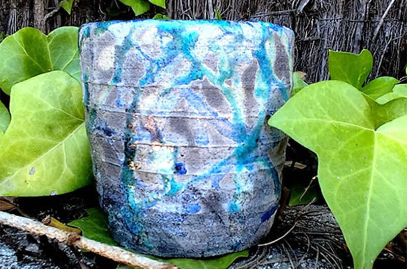 Image of ceramic artwork in foliage