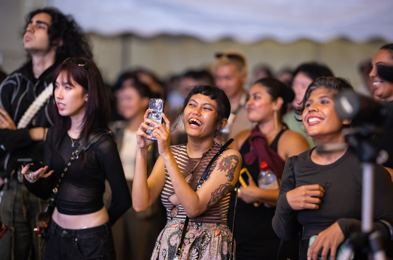 Image of people taking photos and enjoying the music event