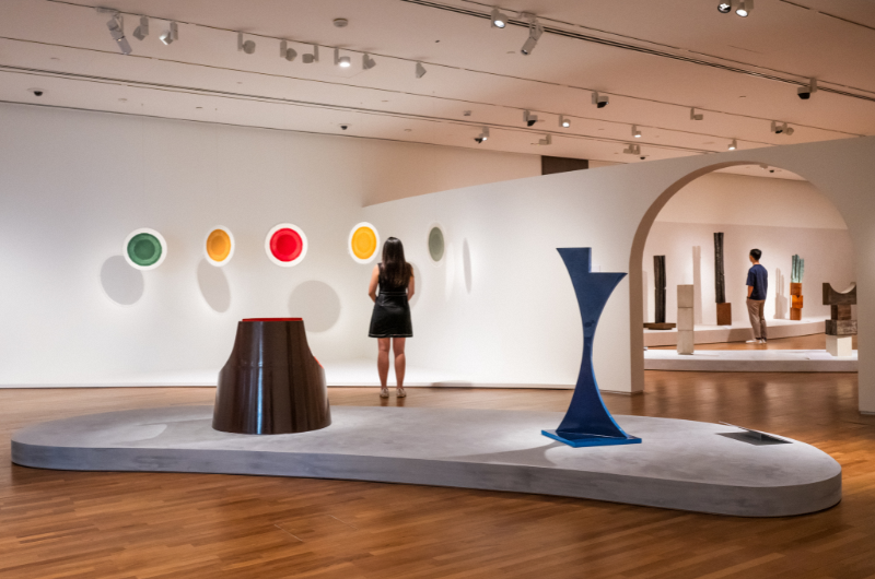 Image of a person looking at the colourful minimal artwork at National Gallery Singapore