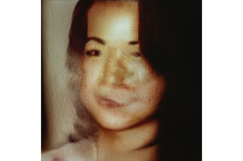 Distorted sepia film photograph of young woman