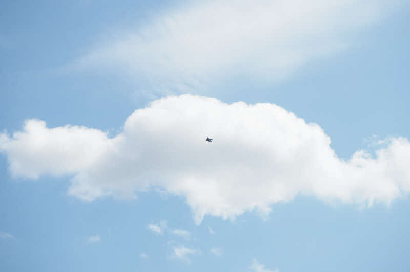 Artwork of clear blue sky with big white cloud