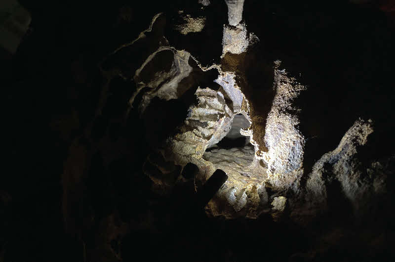 Image of a dark cave with a glow in the centre