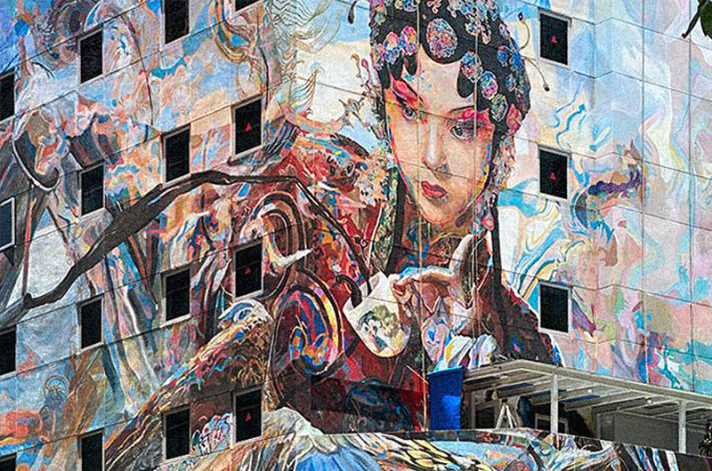 Image of mural of a traditional Chinese opera performer on a building facade