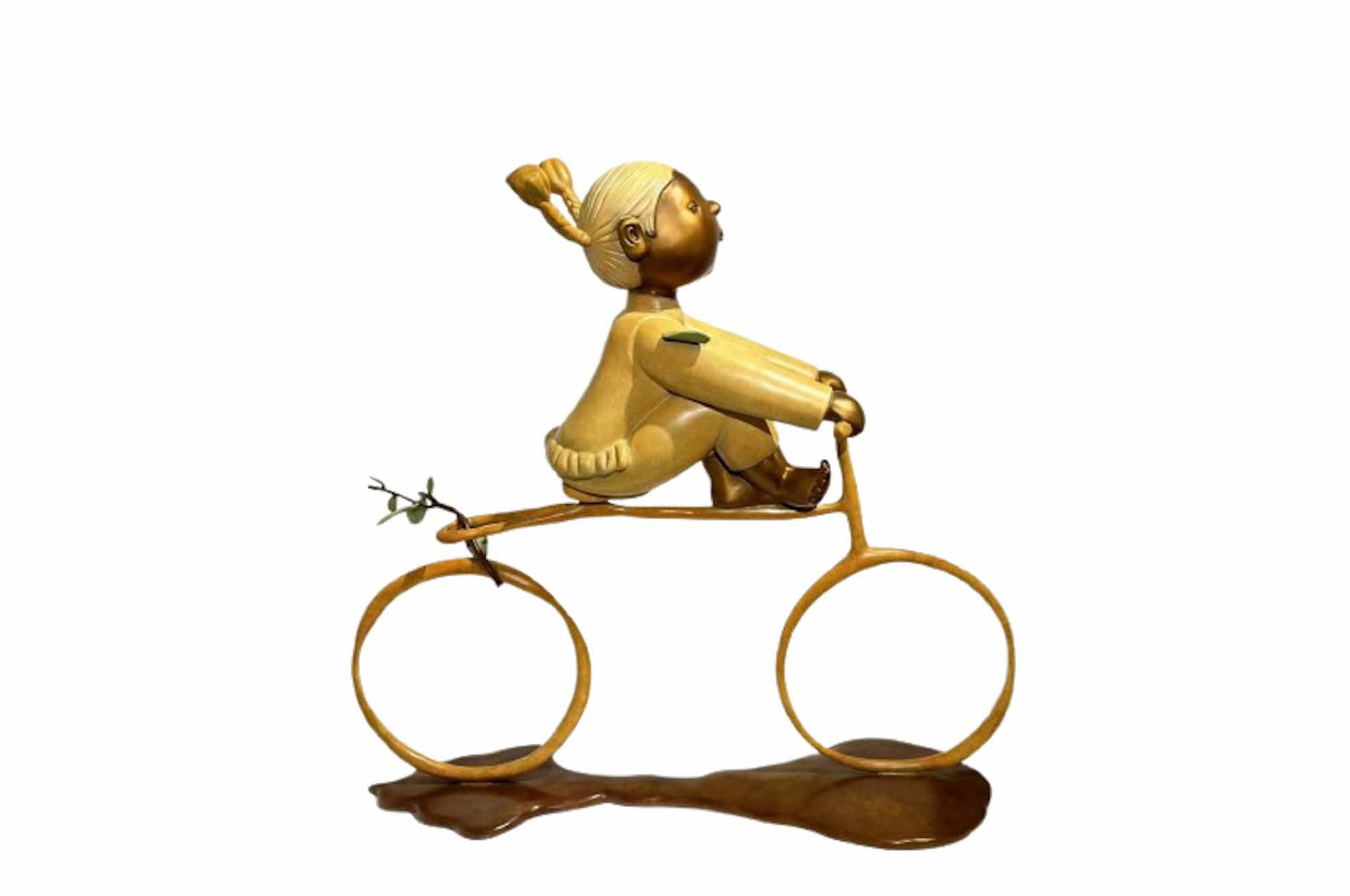 Artwork of young kid riding a bike in gold and brown tones