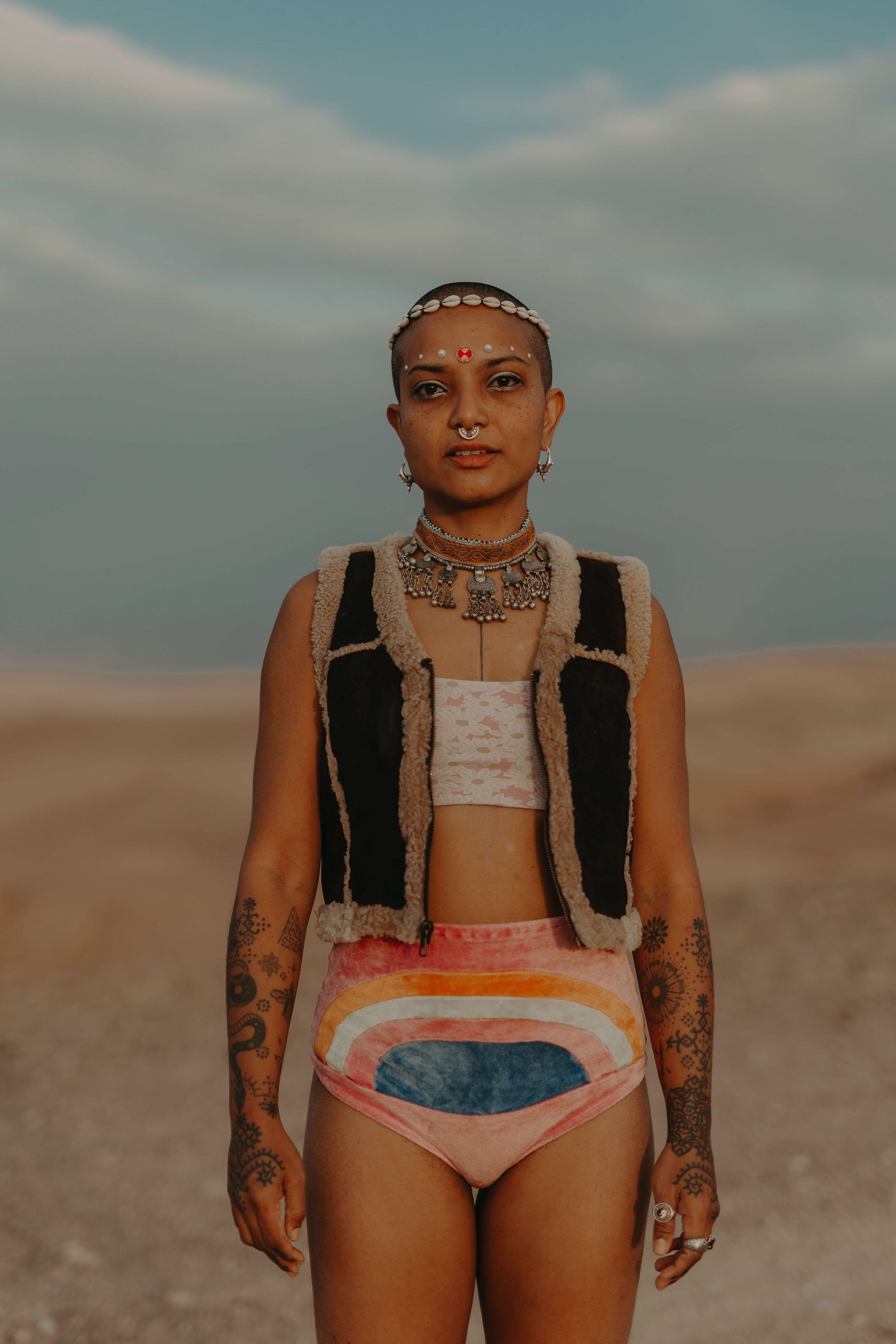 Woman standing on sand looking into the camera