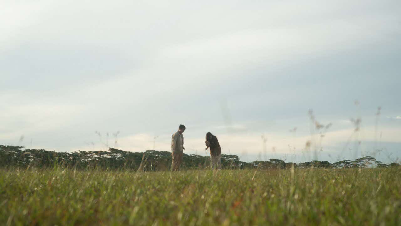 Young man and young woman in a field