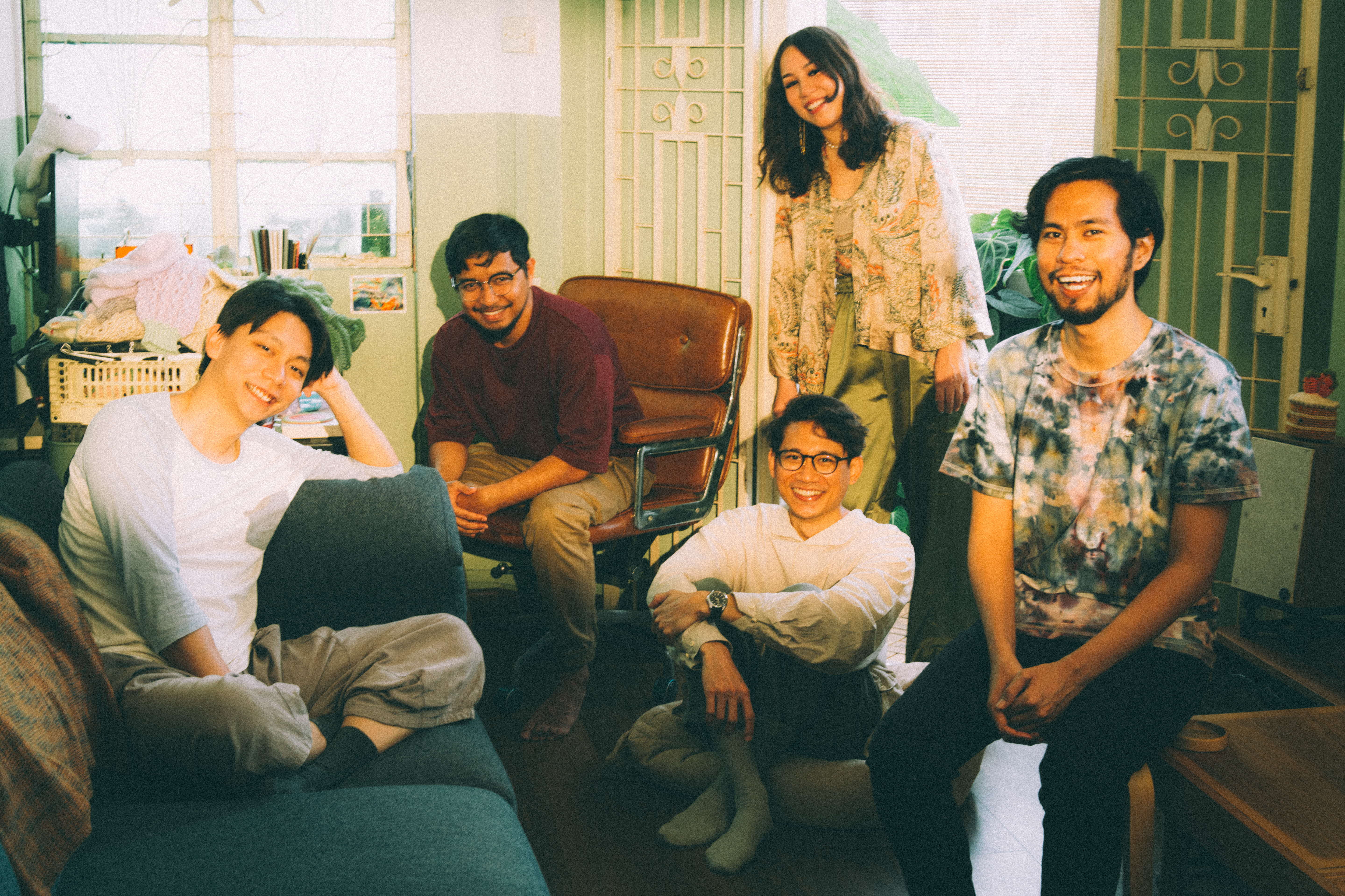 Group of 4 men and 1 woman smiling into the camera